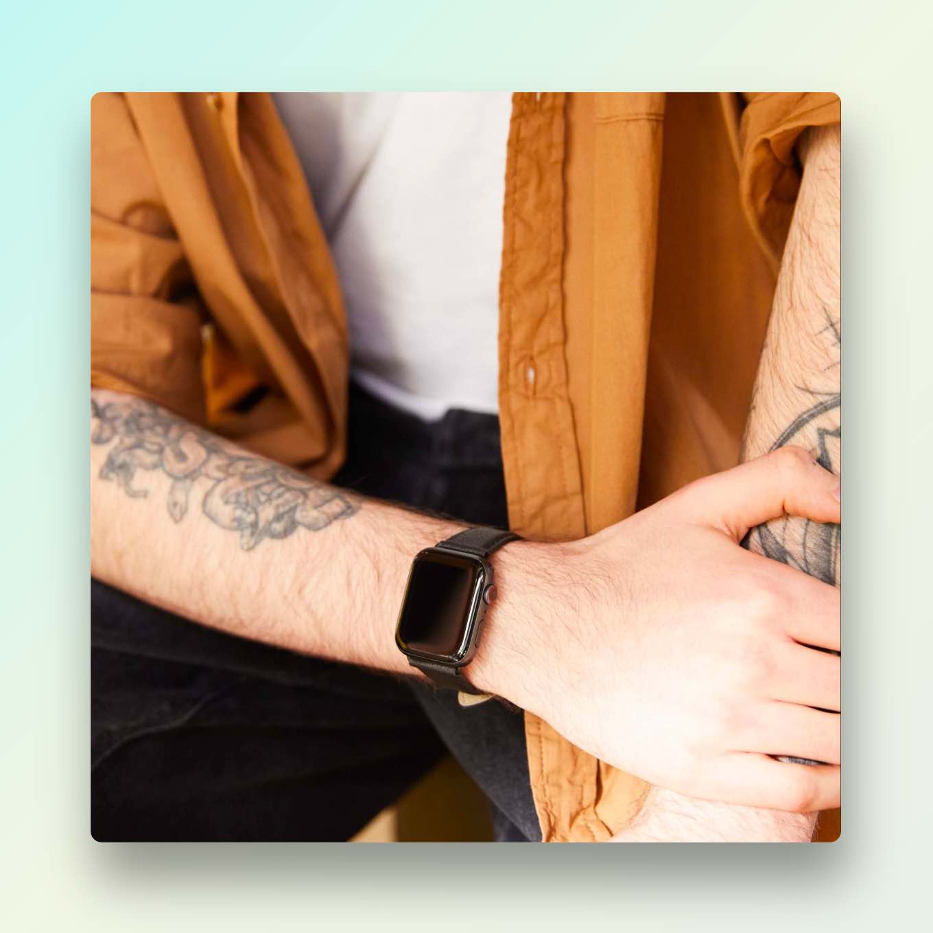 Getatoeëerde persoon die een Apple Watch draagt met een bandje gemaakt van veganistisch appelleer