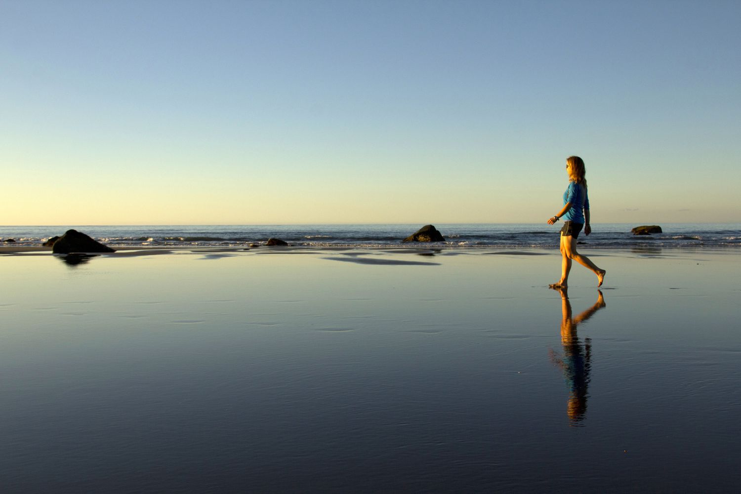 Vrouw die solo op strand loopt